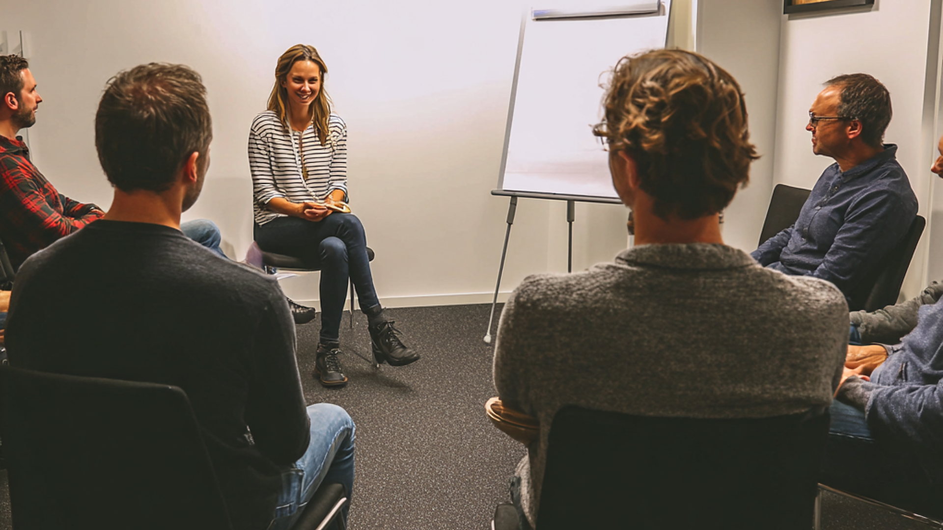A group listening to a speaker in a meeting room